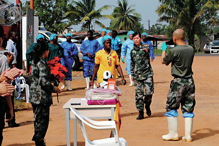 Liberia's last known Ebola patient Beatrice Yardolo (in yellow) arrives for a ceremony at the Chinese Ebola treatment unit