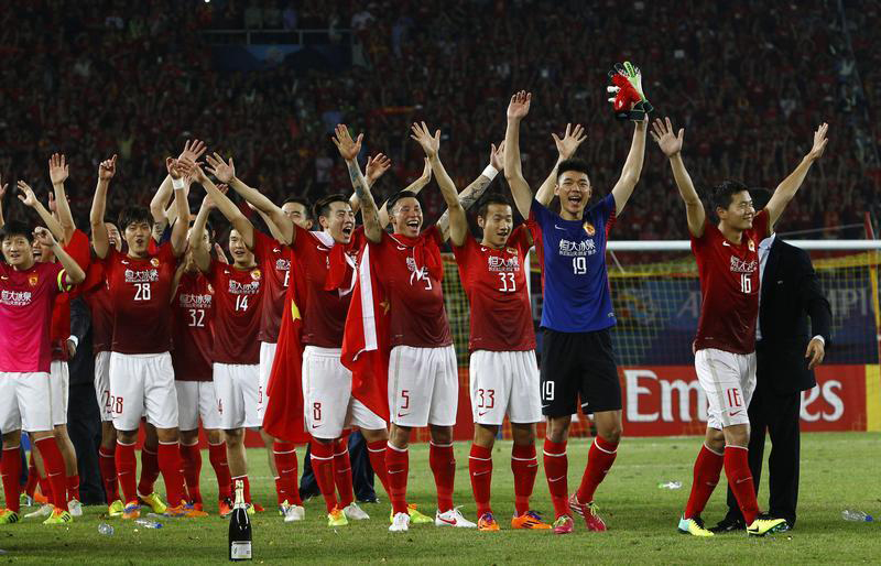 China's Guangzhou Evergrande players celebrate after winning their final match of the AFC Champions' League against South Korea's FC Seoul at Tianhe stadium in the southern Chinese city of Guangzhou N