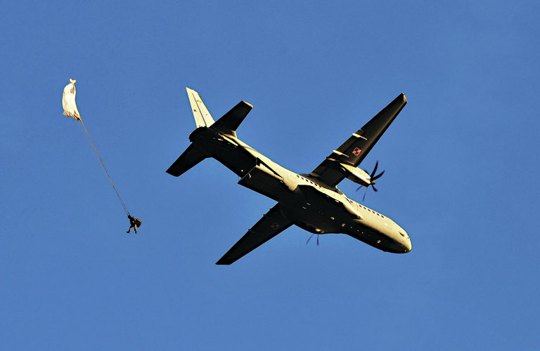 epa04421396 A CASA C-295 twin-turboprop tactical military transport plane of the Polish Army drops a paratrooper during the military exercises 'Anaconda-14' at the Land Forces Training Centre 'Drawsko