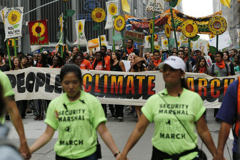 People take part in a march against climate change in New York September 21