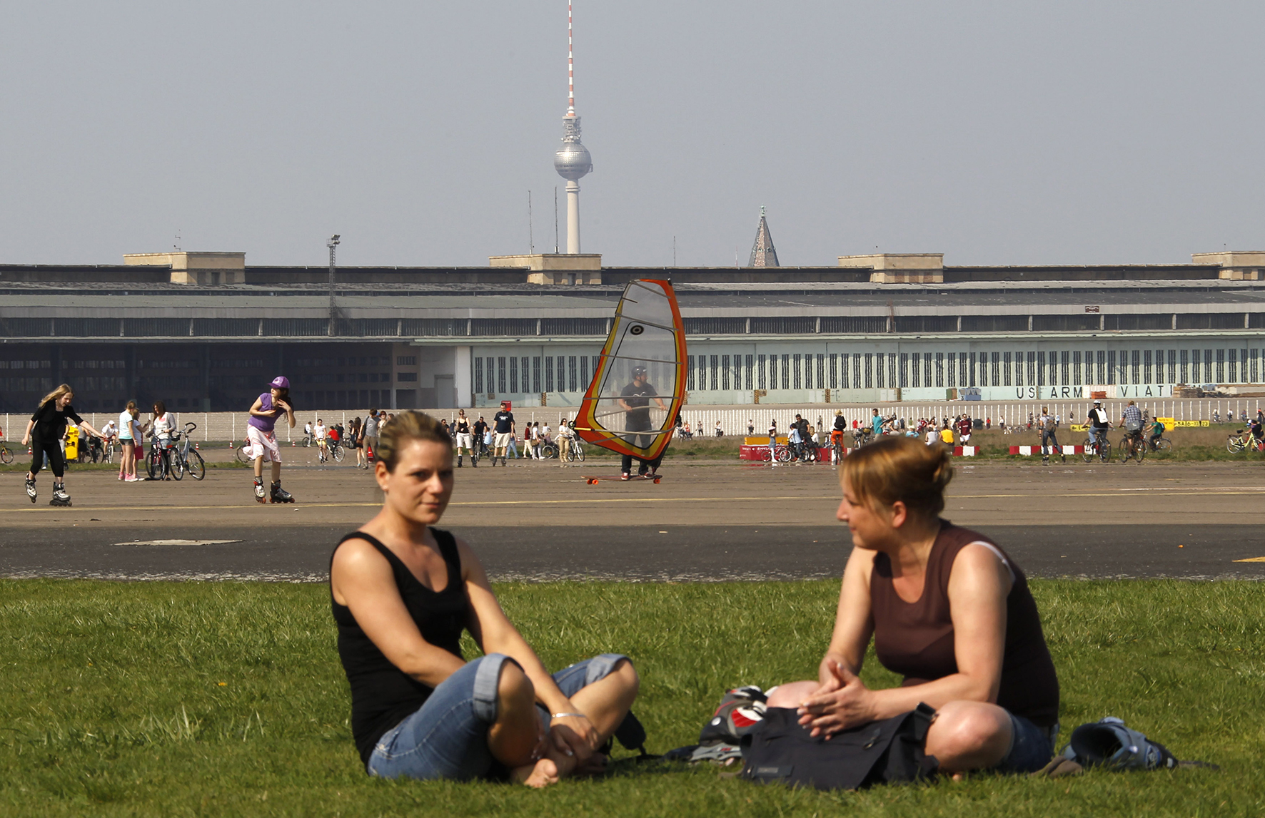 People enjoy a sunny day at tarmac of former Tempelhof airport in Berlin April 22