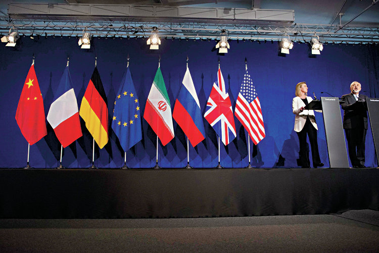 Iranian Foreign Minister Javad Zarif (R) makes a statement as European Union High Representative for Foreign Affairs and Security Policy Federica Mogherini watches