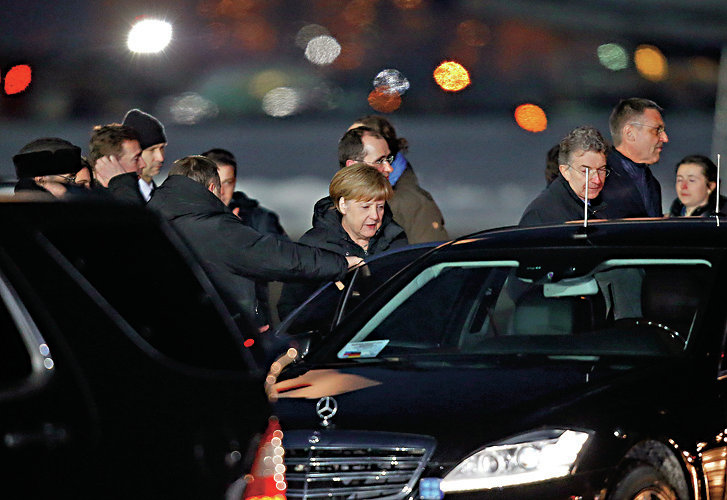 German Chancellor Angela Merkel gets into a car upon her arrival at Moscow's Vnukovo airport February 6
