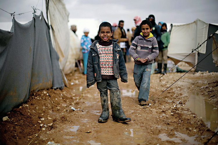 Syrian refugees children play near their family tent at Al Zaatari refugee camp in the Jordanian city of Mafraq