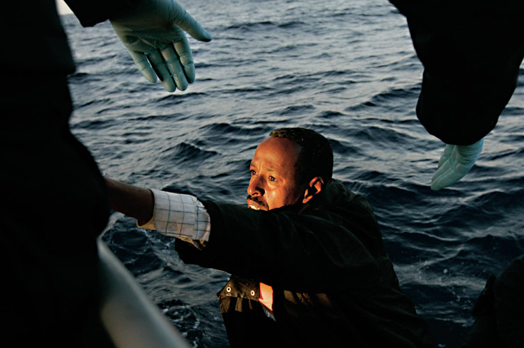 A would-be immigrant climbs onto an Armed Forces of Malta ship after being transferred from a trawlerPICTURE 04 OF 28 FOR WIDER IMAGE STORY 'ISLE LANDERS'SEARCH 'DARRIN ISLE' FOR ALL IMAGES - RTX1